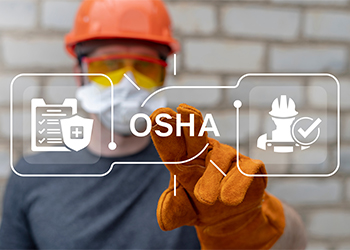 Worker with safety clicking on virtual screen with OSHA acronym