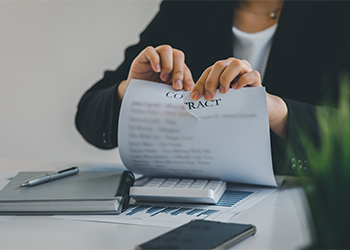 Businesswomen tearing contract at office