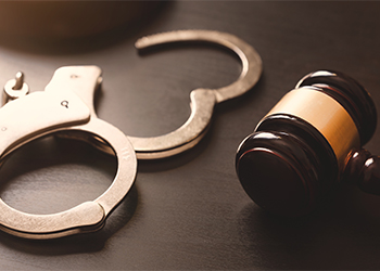 Gavel and open handcuff