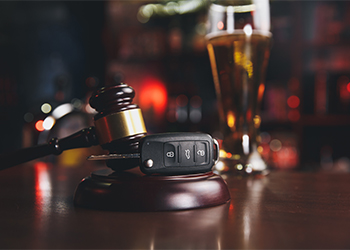 Gavel, Car Keys and Alcohol glass in background