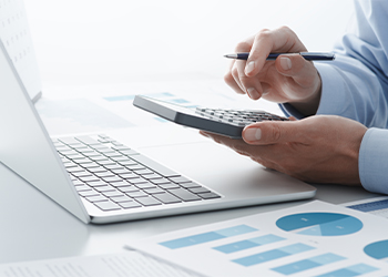 Man calculating tax using calculator