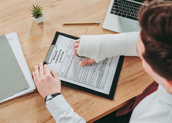 Injured man with worker compensation claim form