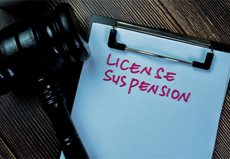 License Suspension write on paperwork with gavel