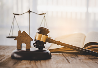 Model of house and gavel real estate