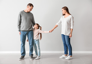 Unhappy family after divorce against light wall