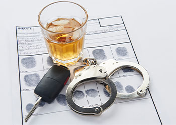 Car keys, handcuffs, glass of alcohol and fingerprint record sheet