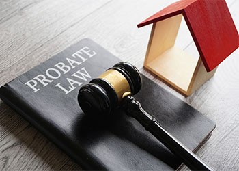 Toy house, gavel and text PROBATE LAW book