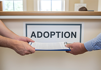Hand give document at adoption counter desk