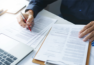 Businessman reviewing document reports at office workplace