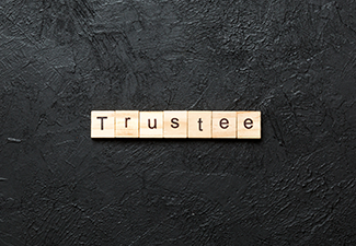 Trustee word written on wood block