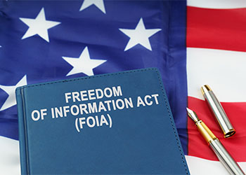 FOIA book and pen on US flag