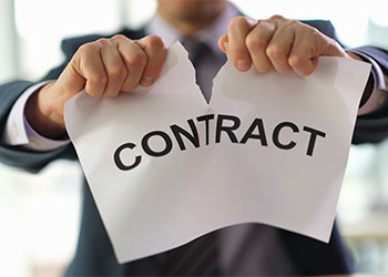 Businessman tearing contract paper in office