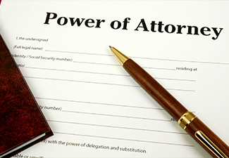 Power Of Attorney form with pen and lawbook