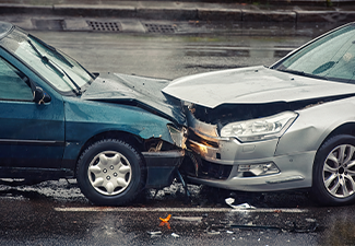Two cars damaged after head-on collision, car crash