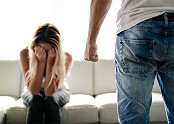 Crying women and man with closed fist, domestic violence image