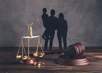 Family figures with gavel and scale of justice