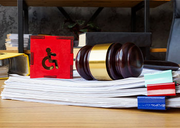Gavel and disabled person sign