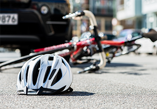 Bicycling helmet fallen next to a bicycle after accident