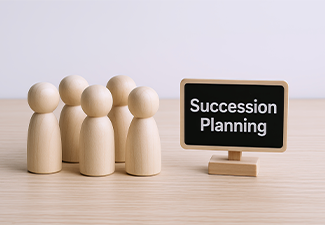 Wooden figurines representing a succession planning concept with a chalkboard