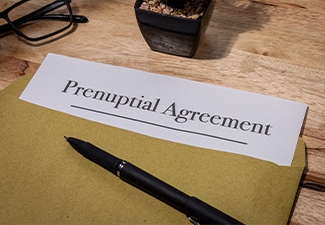 Prenuptial Agreement Document Resting on Wooden Desk