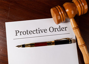Protective Order file with gavel and pen on table