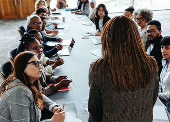 Manager leading business meeting with diverse team