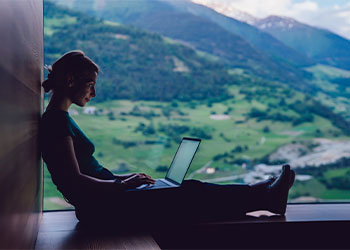 Skilled female digital nomad working remotely