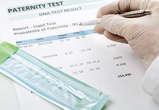 Doctor points at result on paternity test result form