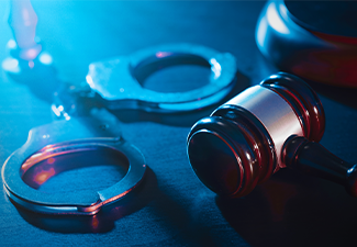 Crime and violence concept with handcuffs and gavel