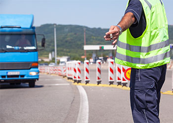 Highway traffic police signaling blue truck to stop