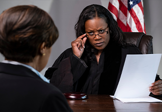 A judge looking at attorney with concern in courtroom