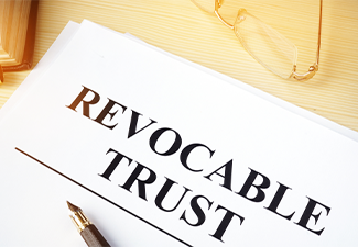 Revocable trust on a wooden desk with pen