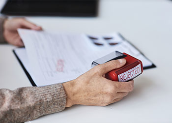 Visa Counseller with rejected stamp on hand