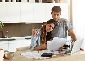 Couples with financial problems sitting in kitchen