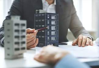 Real estate developer and architect discussing new housing development project in office