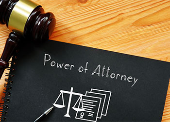 Power of Attorney text in black paper with gavel