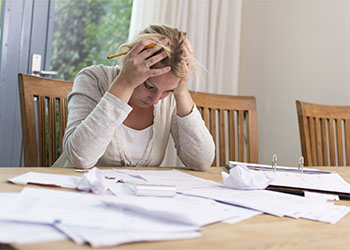 Frustrated women while calculating debt