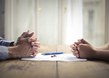 Couples with divorce document in table