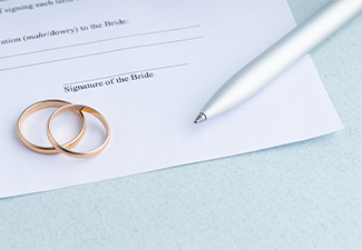 Marriage contract form of prenuptial agreement with a pair of wedding rings