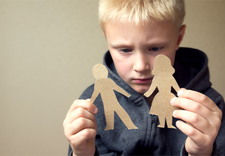 Confused child with paper parents figure