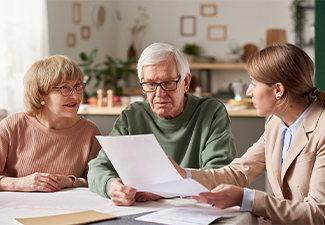 Senior couple sitting at the table and discussing will documents