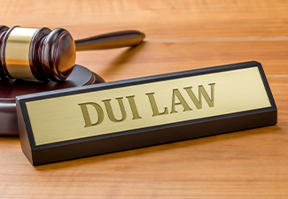 A gavel and a name plate with the engraving DUI Law