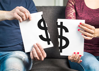 Divorced couples holding ripped paper with dollar sign