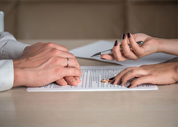 Couples signing divorce paper