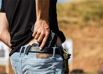 Man hiding gun behind his back