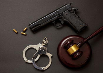 Gavel, Gun and Handcuff in table