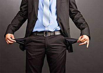 Bankrupt businessman showing empty pocket