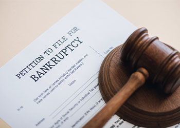 Gavel and Petition to file for bankruptcy on table