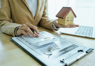 Lawyer Reading Document of Will while Holding Model of House