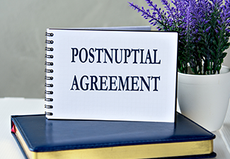 POSTNUPTIAL AGREEMENT - words in a notebook against the background of a diary